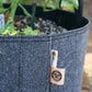 Felt plant grow bags with irrigation line holders.